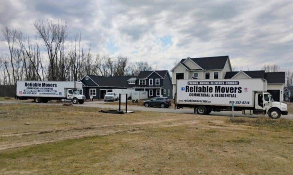 Reliable Movers moving trucks in front of a customers home. 
