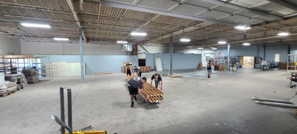 Reliable Movers crew relocating equipment during a factory move in Syracuse, NY, showcasing industrial moving expertise.