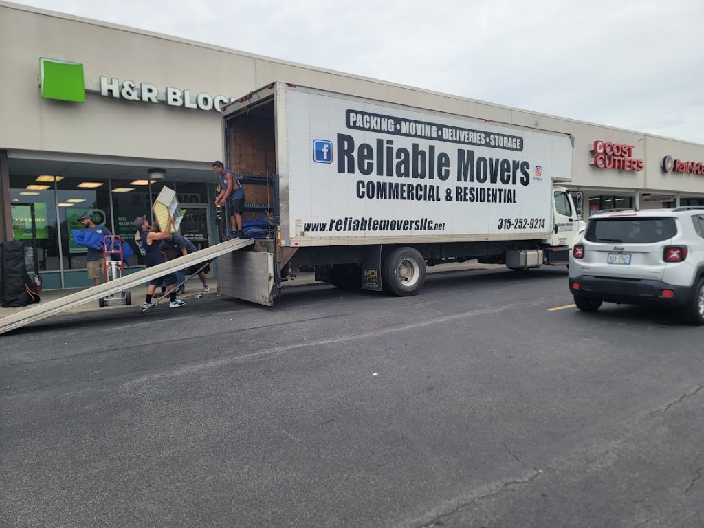 Reliable Movers crew relocating inventory during a commercial antique store move, handling delicate and oversized items with care.