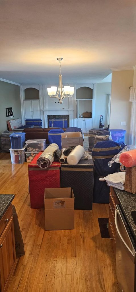 Reliable Movers crew preparing items for a local move to storage with protective packing and organization