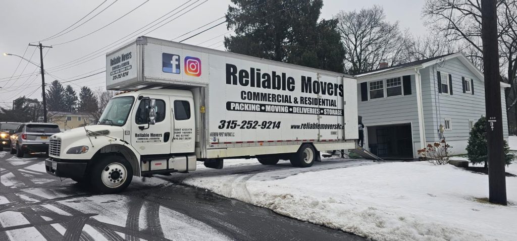 Reliable Movers truck parked outside a home during a local residential move in New York
