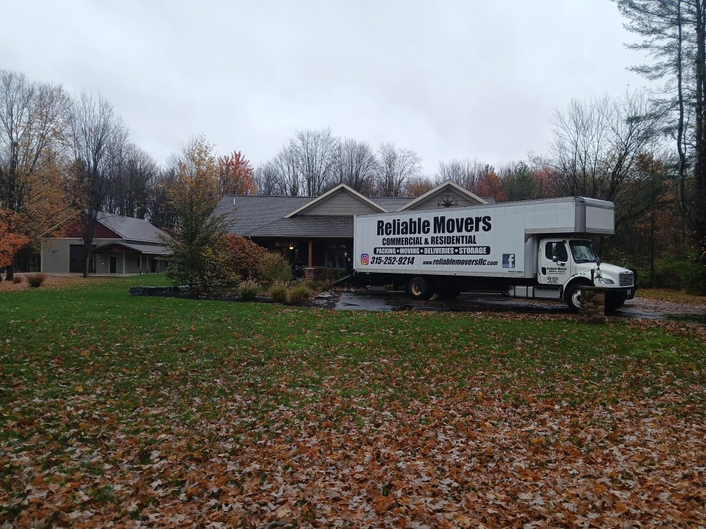 Reliable Movers truck staged outside a home for a local move