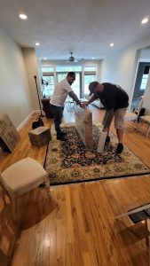 Reliable Movers crew wrapping a painting for safe transport