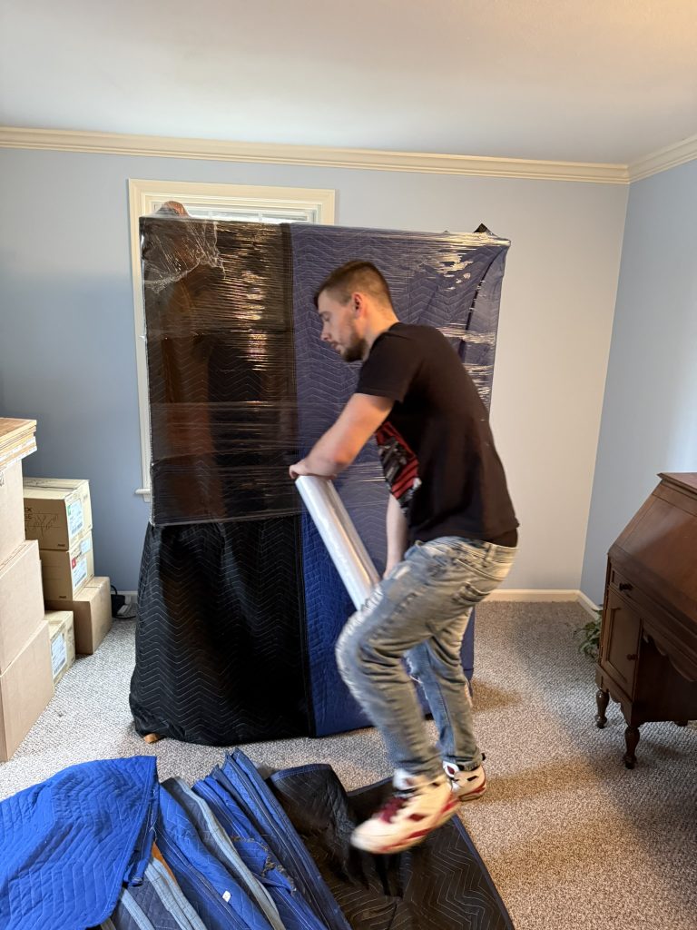 mover shrink wrapping padded furniture for interstate move syracuse to west virginia