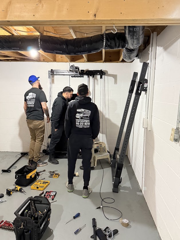 Reliable Movers breaking down a gym set 