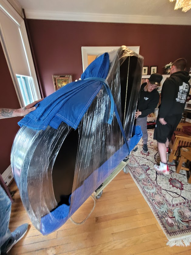 Baby grand piano being wrapped and moved by professional movers in Syracuse NY on April 4 2026
piano movers Syracuse NY