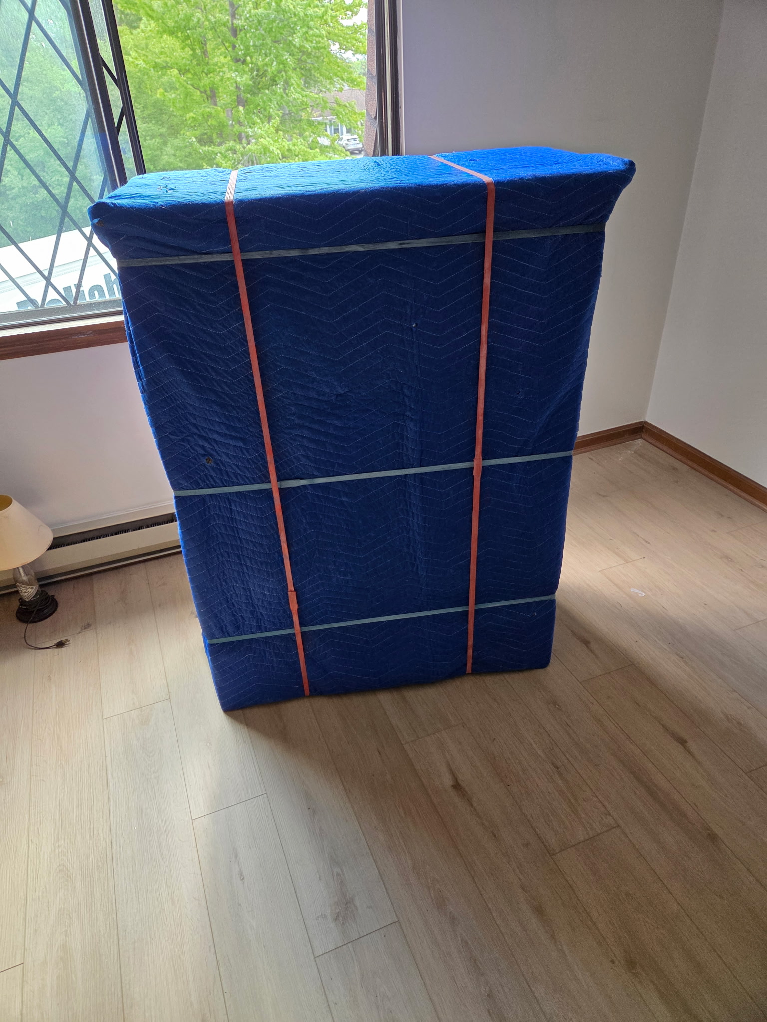Dresser protected with moving blankets and shrink wrap by Reliable Movers for added furniture protection during transport