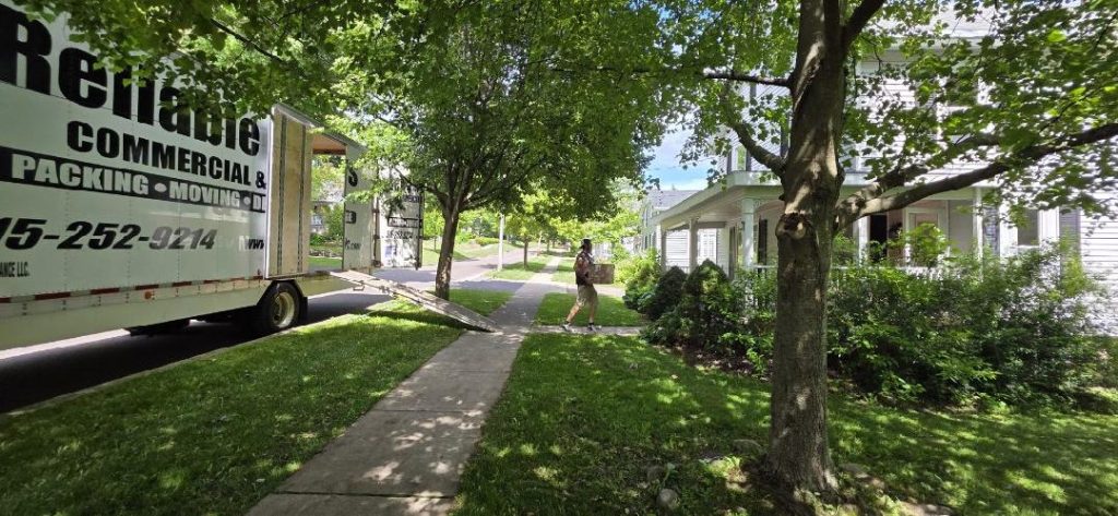 Reliable Movers unloading a customer's household during an interstate move from Pennsylvania to Skaneateles, NY on June 24, 2026. A company-owned moving truck is parked outside the customer's home while our professional crew carefully unloads furniture and belongings.