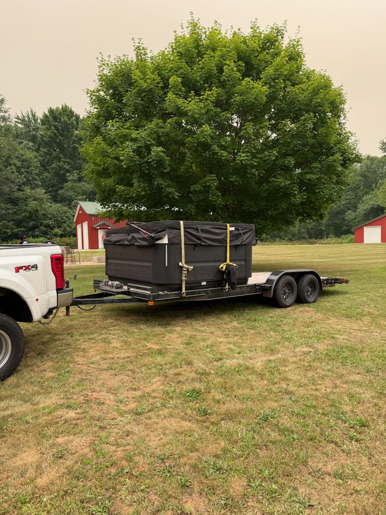 Reliable Movers crew carrying a hot tub during a move in Sterling NY