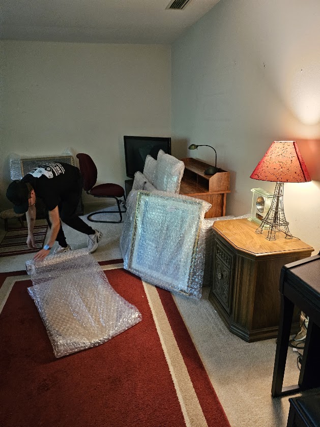 Wrapped artwork and furniture prepared for a move from Manlius NY to North Tonawanda NY