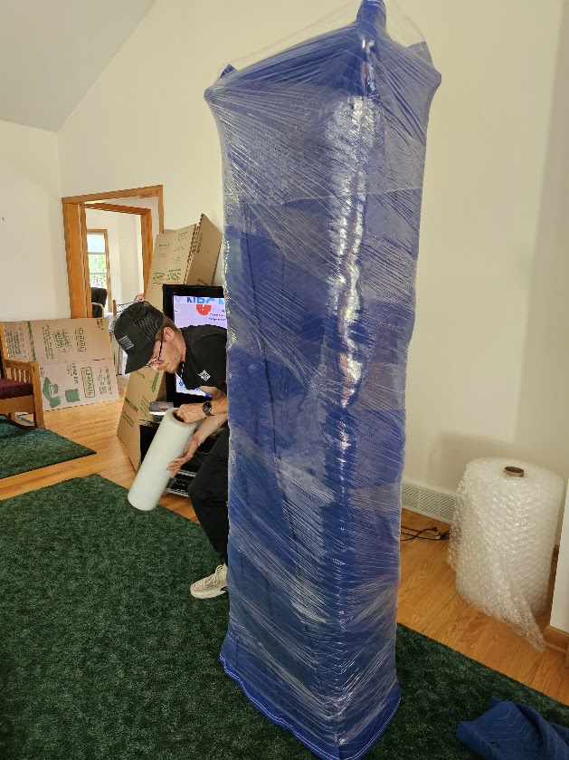 Furniture professionally padded and shrink wrapped before moving from Manlius NY