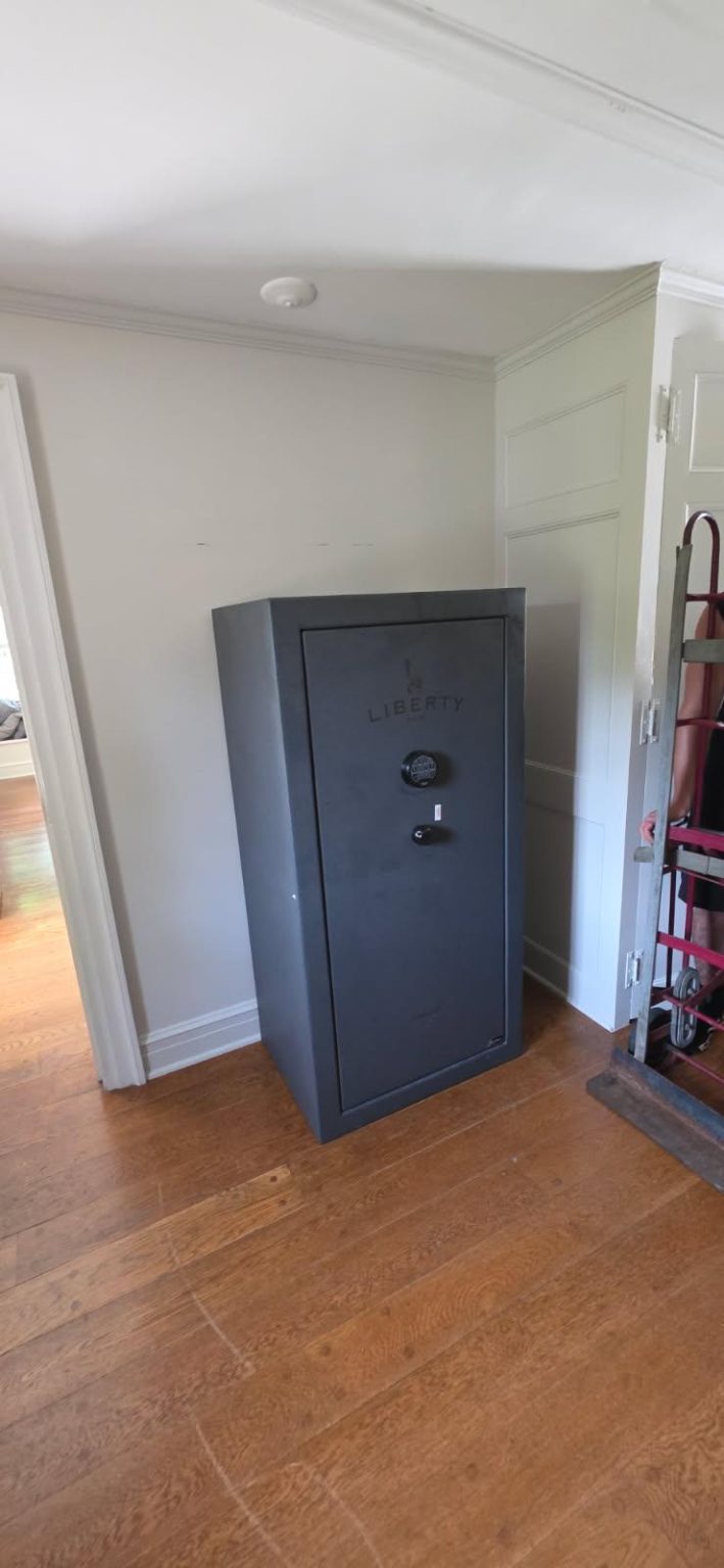 Reliable Movers placing a 600-pound gun safe on the second floor in Rochester NY