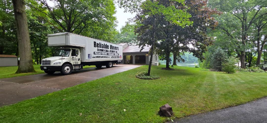 Reliable Movers truck at a Fulton NY home during a local move with overnight load and hold service