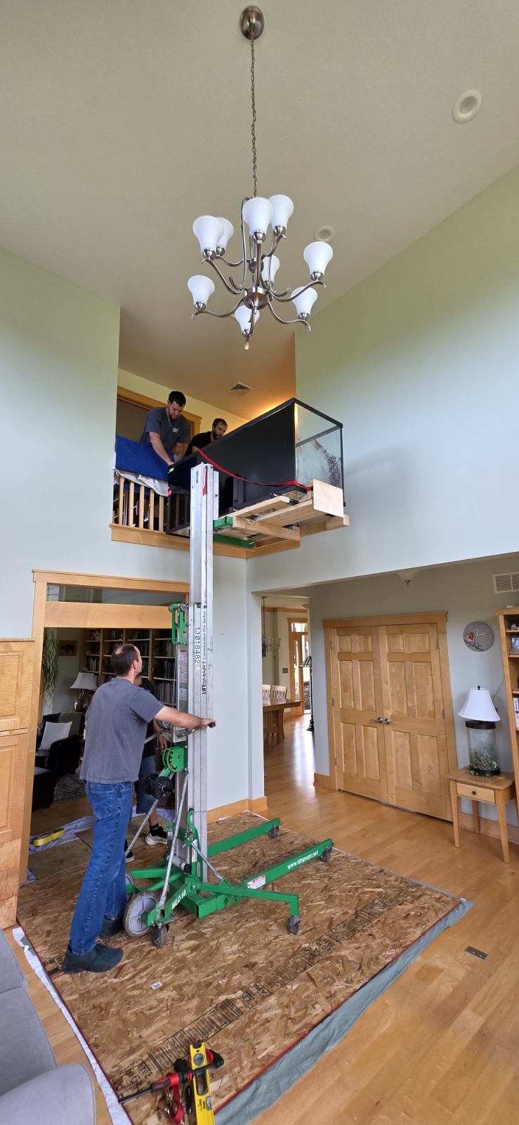 Reliable Movers lifting a 600-pound fish tank to the second floor in Elbridge NY