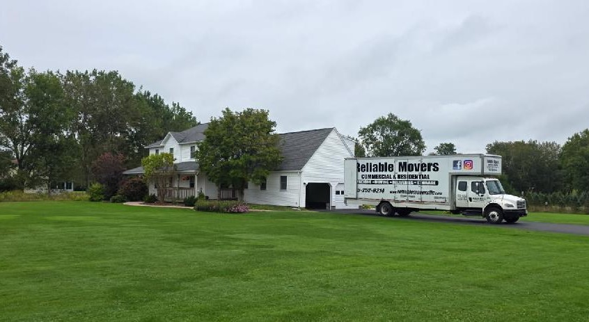 Reliable Movers truck at Auburn NY home for interstate move to Ohio