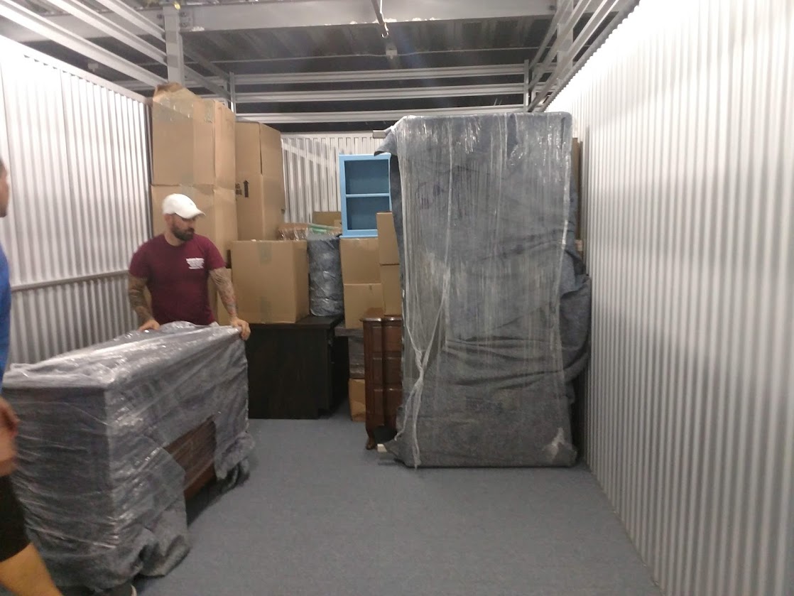 Reliable Movers owner Mike unloading a household shipment into storage