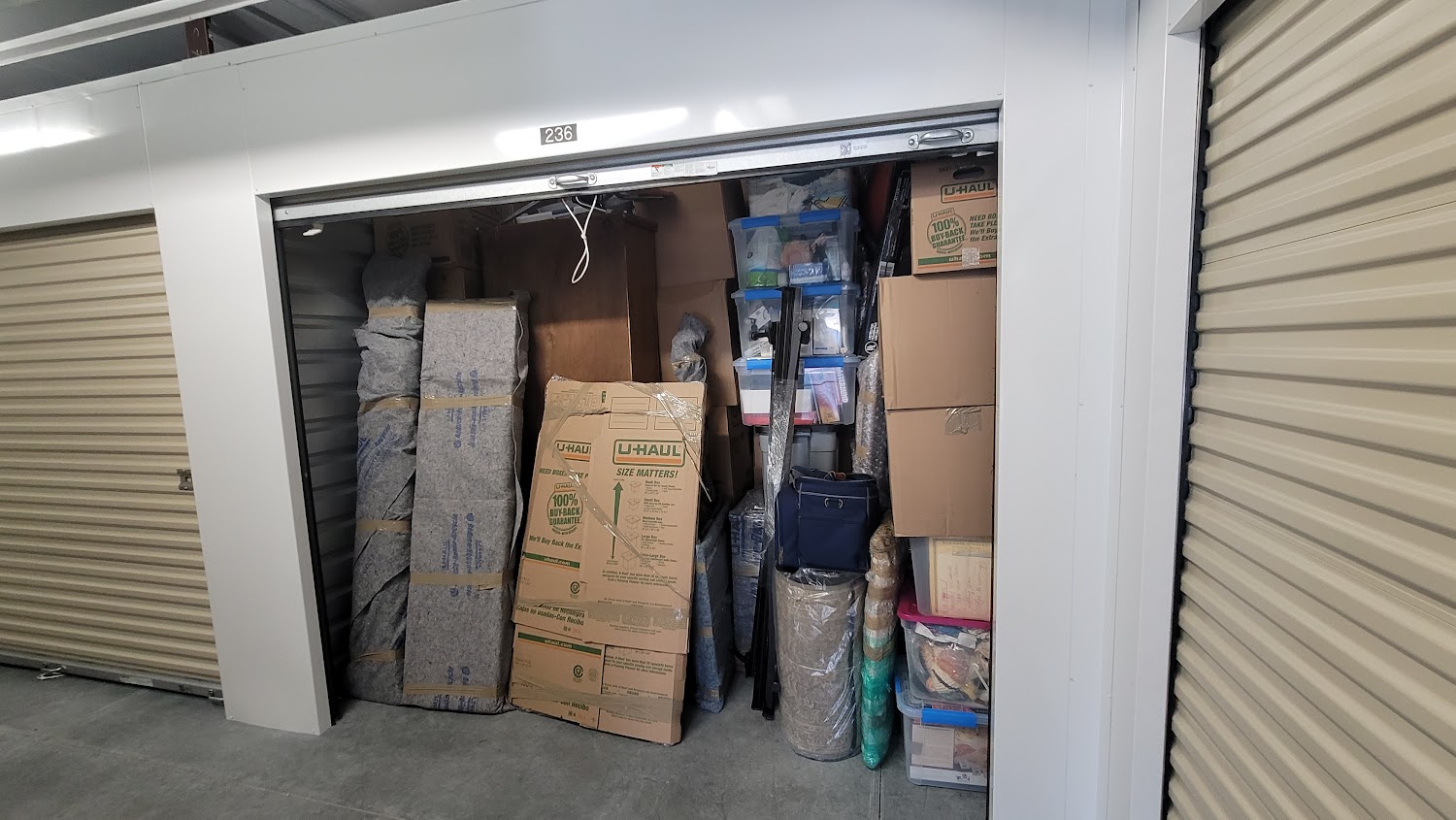 Reliable Movers professionally loading and organizing furniture and boxes in a storage unit