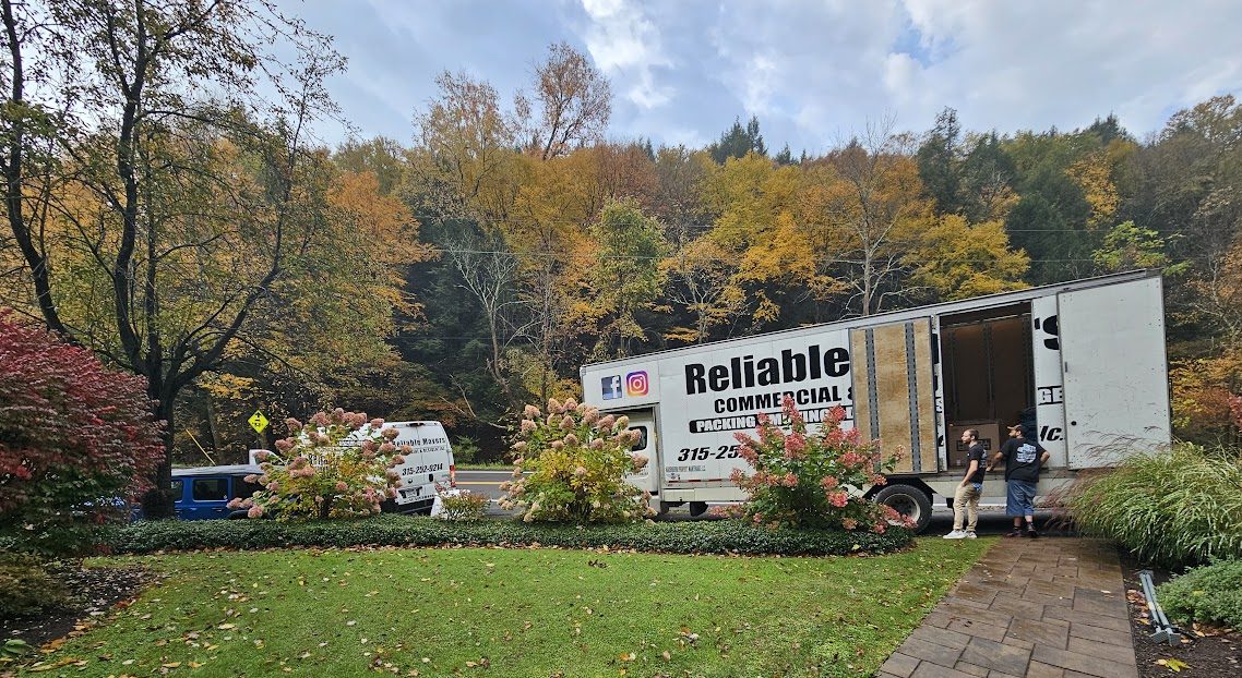 Reliable Movers crew and moving truck at a home in Homer New York before interstate transportation to Massachusetts