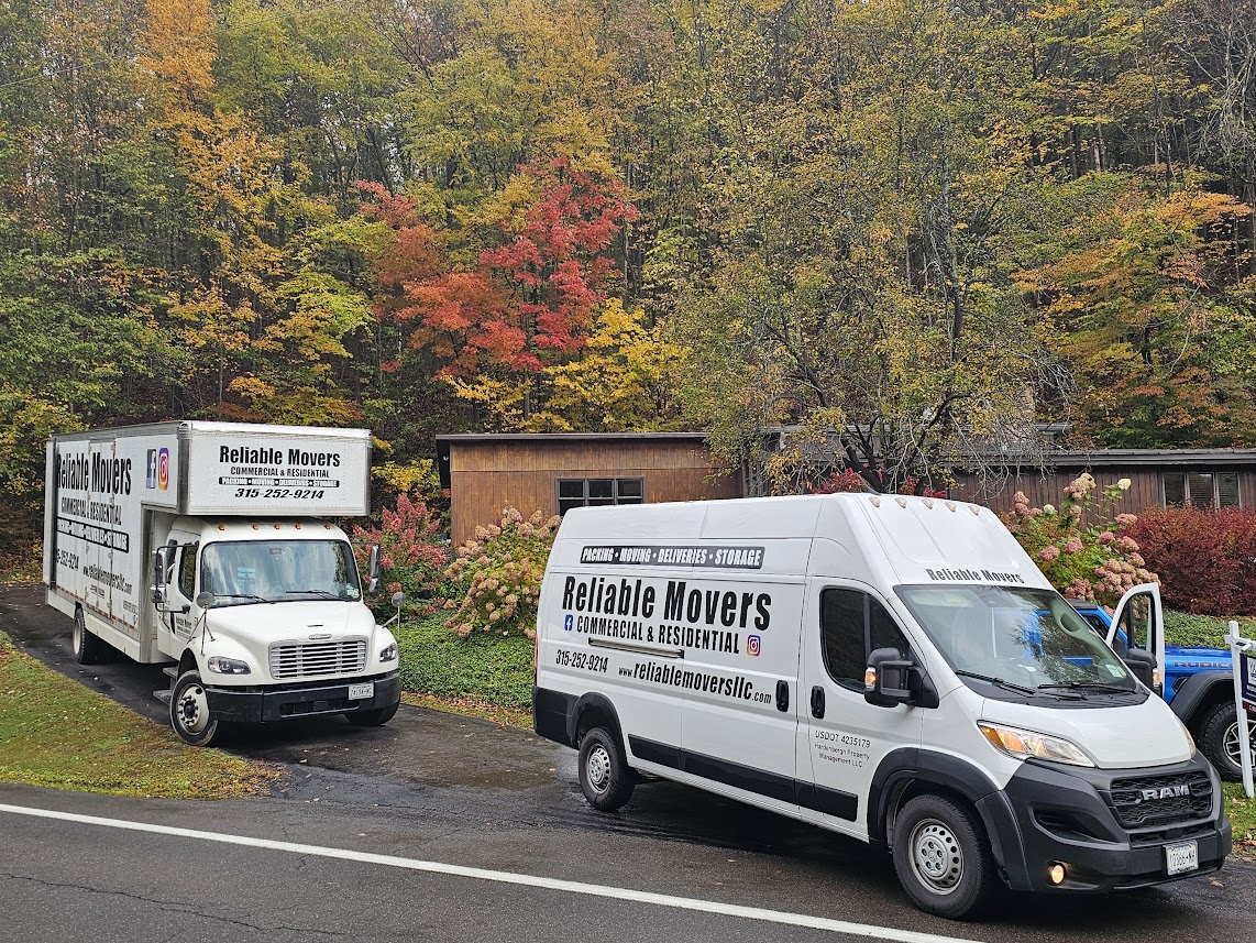 Reliable Movers moving truck and van at a residential loading job in Homer NY for a move to Massachusetts