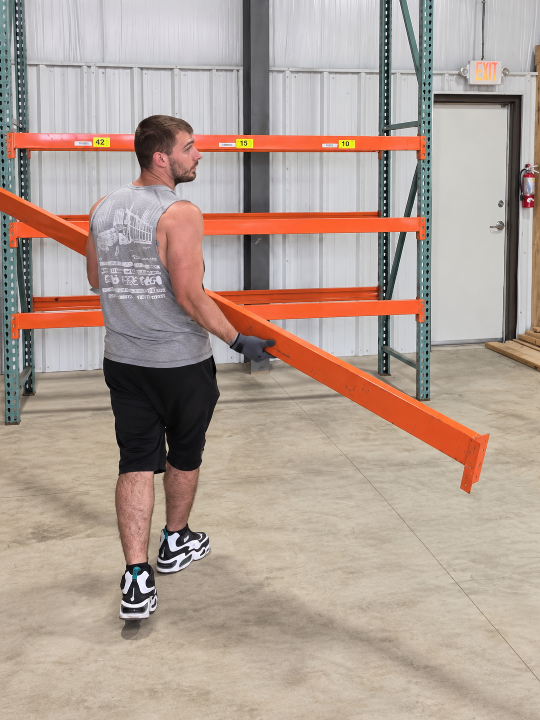 Jonathan, Reliable Movers crew member handling equipment inside a warehouse