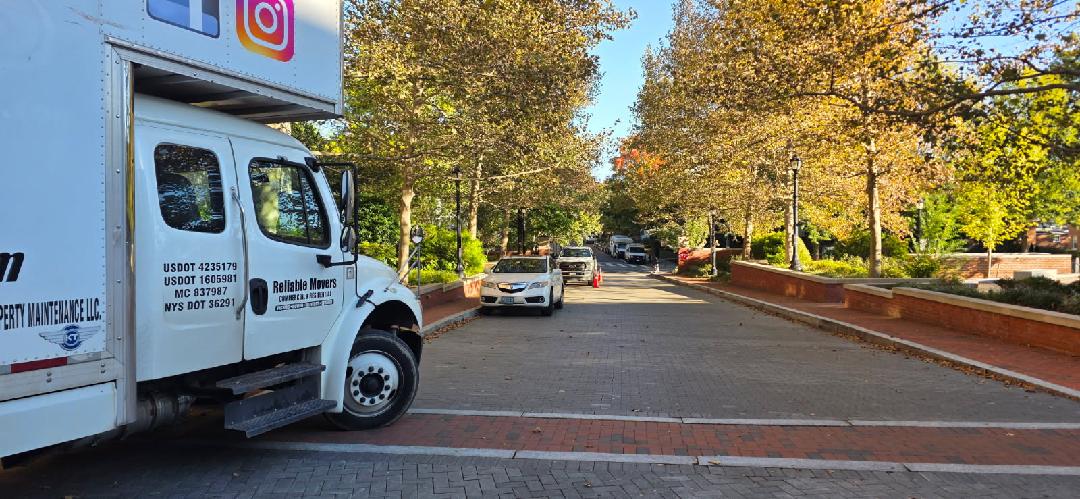 Reliable Movers interstate moving truck parked along a tree-lined street in Washington DC