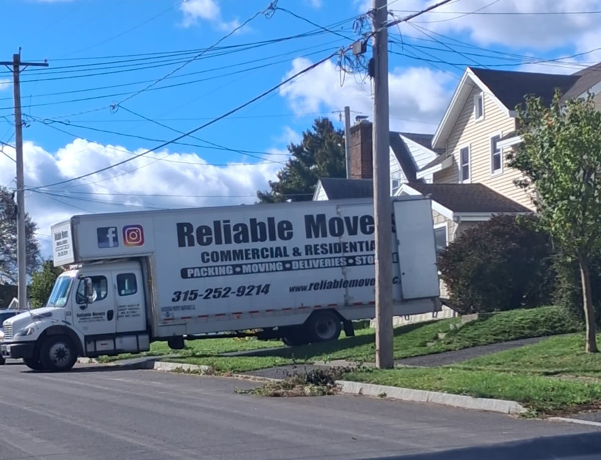 Reliable Movers LLC company moving truck outside a residence during a Syracuse NY to Barre Vermont interstate move on October 9 2026